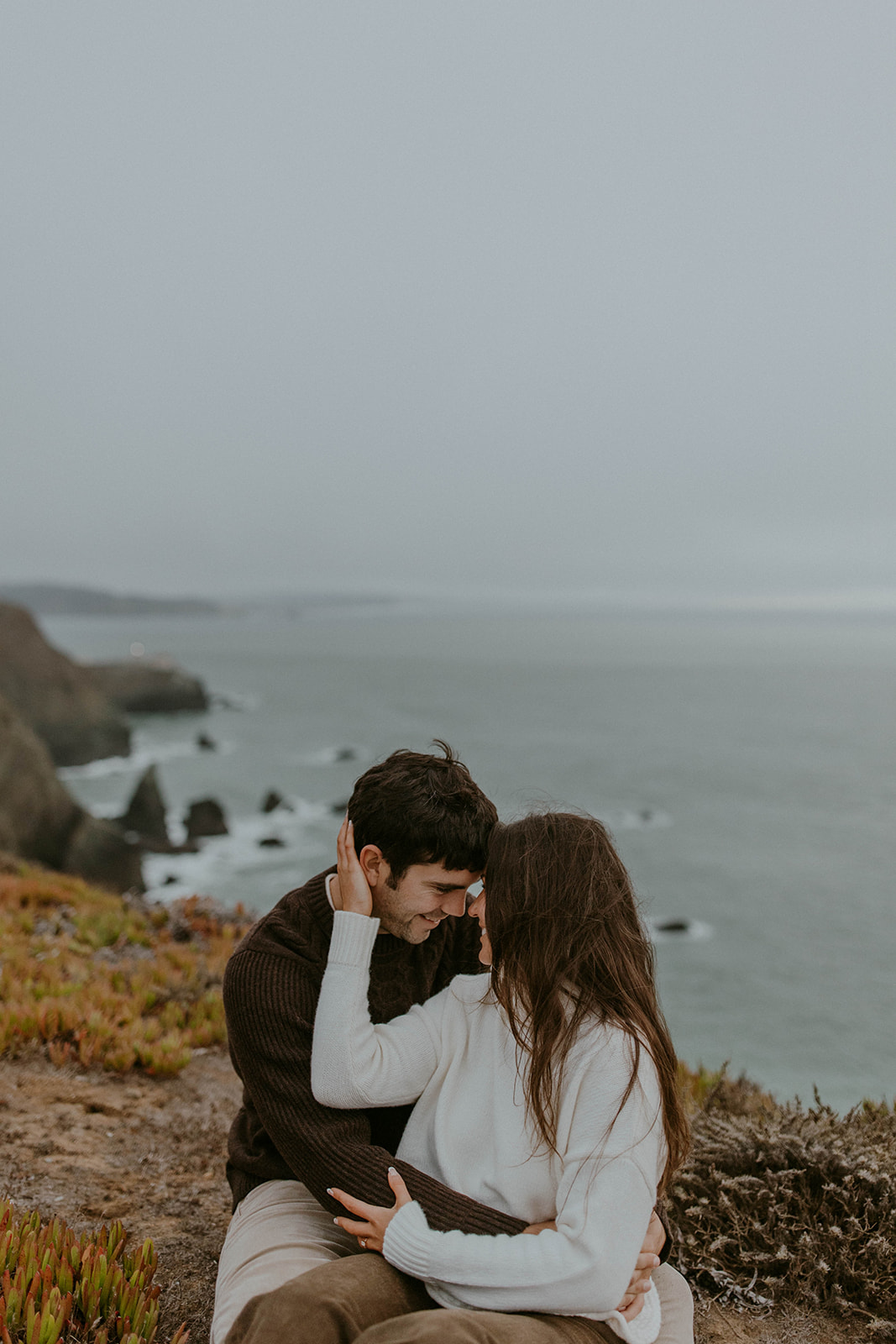 romantic outdoor winter engagement photos in san francisco. the couple embraces in neutral outfits. Photo taken by Codi Baer Photography