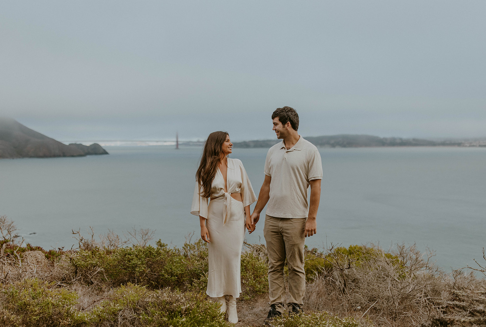 A couple looking at one another during a romantic engagement photo session in san francisco. Photo taken by Codi Baer Photography