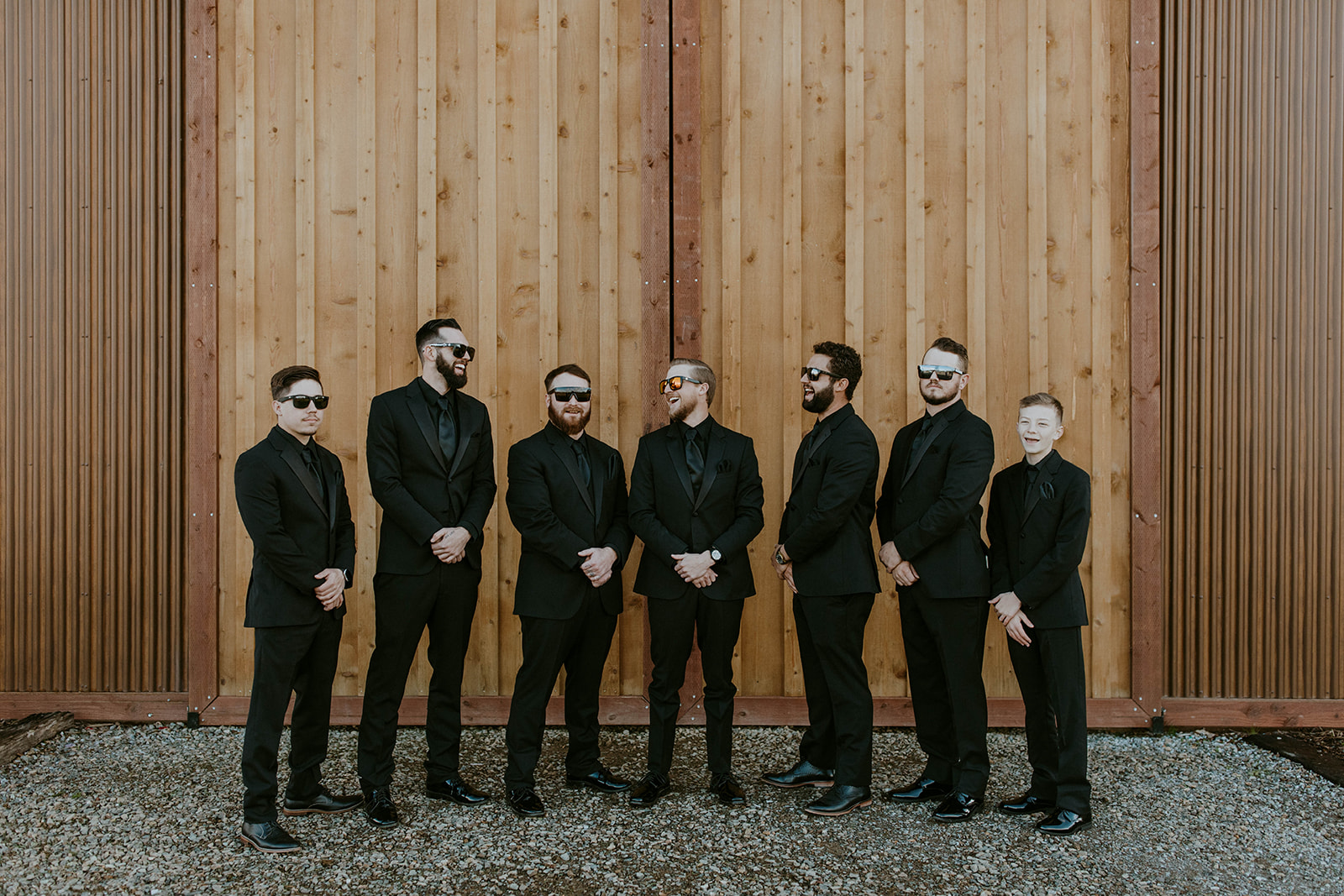 a groom and his groomsmen pose in all black wedding suits during a western winter wedding in california. photo by codi baer photography
