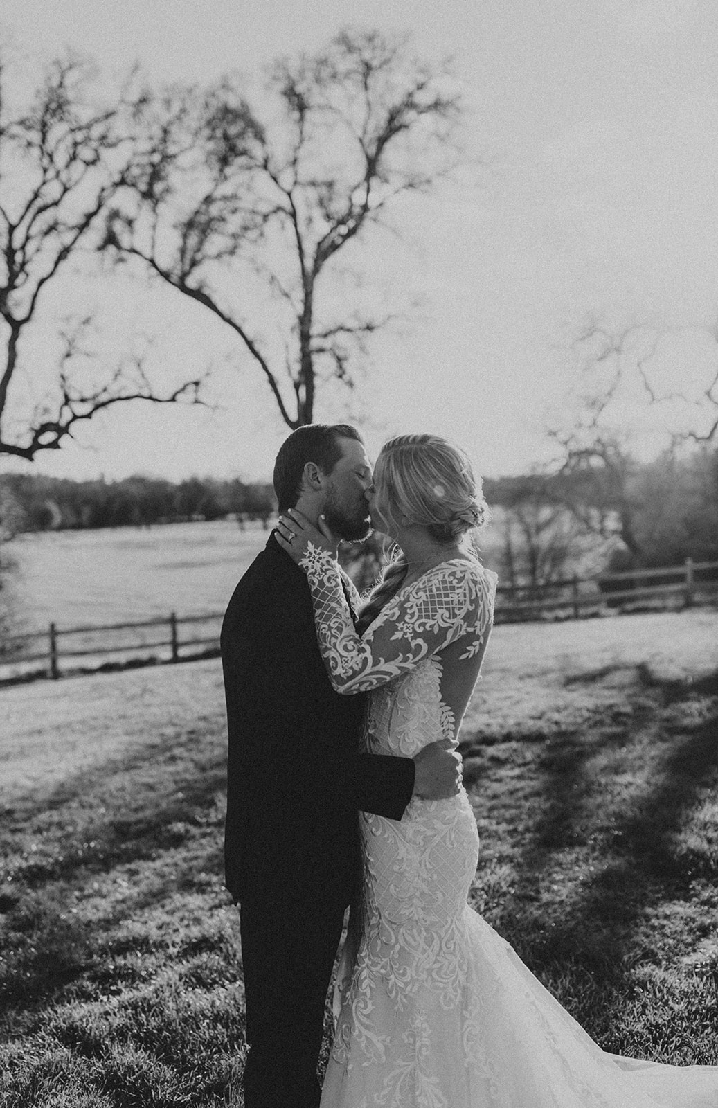 a bride and groom kiss during their western winter wedding. photo by codi baer photography